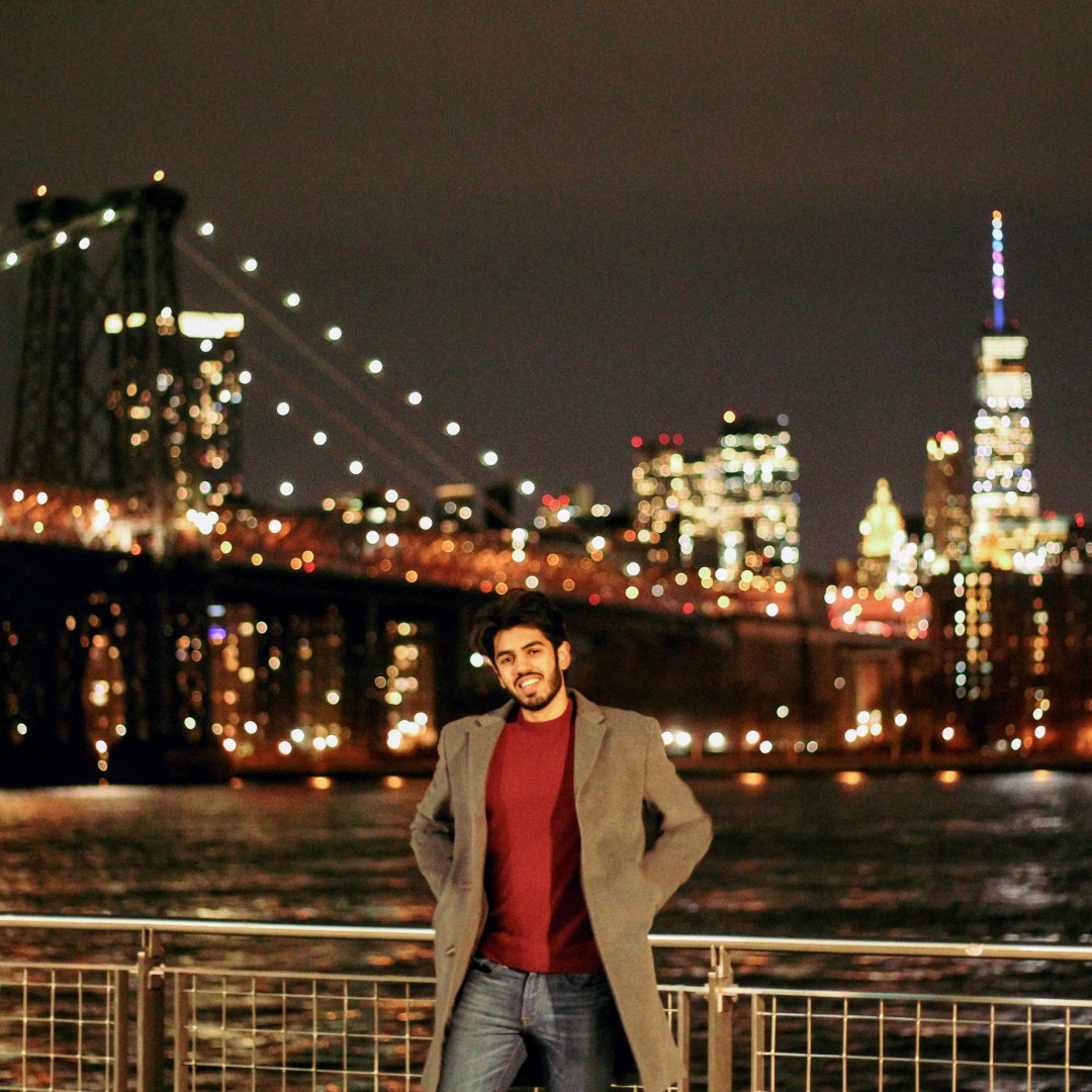 Jamie Pinheiro in front of cityscape background in NYC