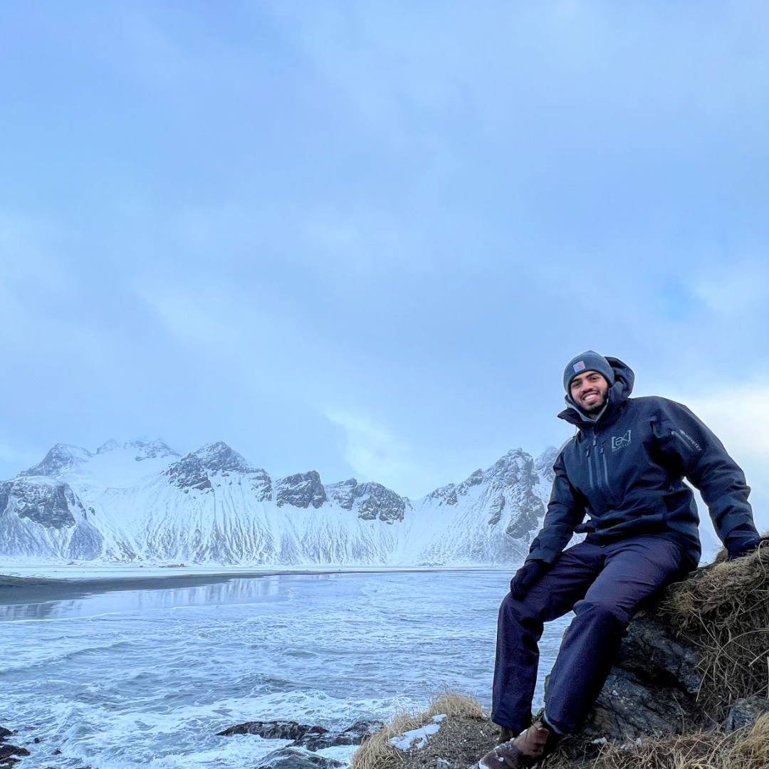Jamie Pinheiro sitting on rock in Iceland